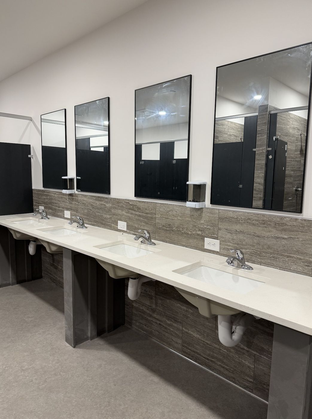 Bath house vanity with four sinks and mirrors